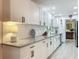 Modern kitchen with granite countertops, white cabinets, and stainless steel appliances at 3443 Arnel Dr, Winter Park, FL 32792