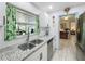 Modern kitchen with granite countertops, white cabinets, and stainless steel appliances at 3443 Arnel Dr, Winter Park, FL 32792