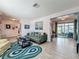 Bright living room with hardwood floors and access to screened in porch at 3443 Arnel Dr, Winter Park, FL 32792
