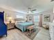The main bedroom has a ceiling fan, light colored walls, and wood floors at 3443 Arnel Dr, Winter Park, FL 32792