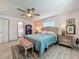 Light-filled main bedroom featuring a ceiling fan, ensuite bathroom, and stylish décor at 3443 Arnel Dr, Winter Park, FL 32792