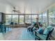 Bright sun room with ample windows providing views of the backyard landscaping at 3443 Arnel Dr, Winter Park, FL 32792