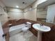Neutral bathroom features a tub with shower and updated pedestal sink at 510 Cranes Way # 302, Altamonte Springs, FL 32701