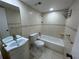 Updated bathroom with tiled walls, tub, and shower has a vanity and sink at 510 Cranes Way # 302, Altamonte Springs, FL 32701