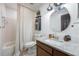 Bathroom featuring updated vanity, mirror, lighting, and shower with curtain at 5113 Mystic Point Ct, Orlando, FL 32812