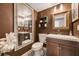 Stylish bathroom with dark brown walls, decorative tile flooring, vanity with sink, and decorative mirror at 5113 Mystic Point Ct, Orlando, FL 32812