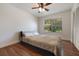 Comfortable bedroom features a ceiling fan, a large window, and ample closet space at 5113 Mystic Point Ct, Orlando, FL 32812