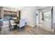 Dining area with wood-look floors, chandelier, seamlessly connecting to adjacent living spaces at 5113 Mystic Point Ct, Orlando, FL 32812