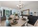 Open dining area features wood-look floors and a dining table set for a meal at 5113 Mystic Point Ct, Orlando, FL 32812