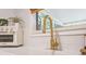 Kitchen close-up features stainless steel appliances, white countertops, and a modern faucet at 5113 Mystic Point Ct, Orlando, FL 32812