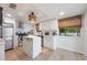 Bright kitchen features white cabinets, stainless steel appliances, an island and light wood floors at 5113 Mystic Point Ct, Orlando, FL 32812
