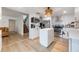 Open kitchen layout with an island, stainless steel appliances, and light wood floors at 5113 Mystic Point Ct, Orlando, FL 32812