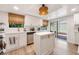 Kitchen has stainless appliances, island and overlooks screened patio for indoor/outdoor feel at 5113 Mystic Point Ct, Orlando, FL 32812