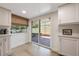 Kitchen leads out to a screened patio through sliding glass doors, enhancing indoor-outdoor living at 5113 Mystic Point Ct, Orlando, FL 32812