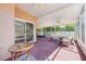 Expansive screened patio with multiple ceiling fans and comfortable outdoor furnishings at 5113 Mystic Point Ct, Orlando, FL 32812