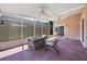 Inviting screened patio with ceiling fans, a fire pit, and cozy seating area at 5113 Mystic Point Ct, Orlando, FL 32812
