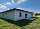 Corner view of the home's back yard with sliding glass door at 529 Marion Oaks Ln, Ocala, FL 34473