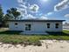 Exterior view of back of house with sliding glass door to concrete patio at 529 Marion Oaks Ln, Ocala, FL 34473