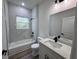 Modern bathroom featuring a marble tiled shower and granite countertop vanity at 529 Marion Oaks Ln, Ocala, FL 34473
