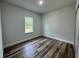 Cozy bedroom featuring wood flooring and a bright window with natural light at 529 Marion Oaks Ln, Ocala, FL 34473