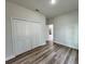 Bright bedroom featuring a closet and wood-look laminate flooring at 529 Marion Oaks Ln, Ocala, FL 34473