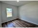 Cozy bedroom featuring wood flooring and a bright window with natural light at 529 Marion Oaks Ln, Ocala, FL 34473
