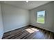 Bedroom featuring wood look flooring and natural light from the window at 529 Marion Oaks Ln, Ocala, FL 34473