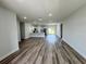 Bright, open-concept living room with modern wood flooring and a view of the kitchen at 529 Marion Oaks Ln, Ocala, FL 34473