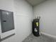 Utility room with hot water heater, cement block wall, and circuit breaker at 529 Marion Oaks Ln, Ocala, FL 34473
