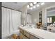 The bathroom features a shower with a curtain, a toilet, and a large vanity at 5575 Garden Grove Cir, Winter Park, FL 32792