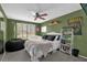 This bedroom features bright green walls, comfortable seating, and ample natural light at 5575 Garden Grove Cir, Winter Park, FL 32792