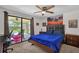 Comfortable bedroom featuring sliding door access to the outdoor patio and pool area at 5575 Garden Grove Cir, Winter Park, FL 32792