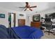 This bedroom features a ceiling fan, a dresser with a TV, and a computer and desk setup at 5575 Garden Grove Cir, Winter Park, FL 32792