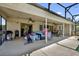 Spacious covered patio featuring ceiling fans, comfortable seating, and an outdoor barbecue area at 5575 Garden Grove Cir, Winter Park, FL 32792