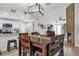 Open-concept dining space with a wooden table adjacent to a kitchen and fireplace at 5575 Garden Grove Cir, Winter Park, FL 32792