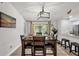 Bright dining area featuring a modern light fixture and sliding glass doors leading to the outdoors at 5575 Garden Grove Cir, Winter Park, FL 32792