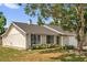 Charming single-story home featuring a well-maintained lawn and mature trees providing ample shade at 5575 Garden Grove Cir, Winter Park, FL 32792