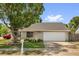 Traditional style home with an attached garage and well-manicured front yard showcasing curb appeal at 5575 Garden Grove Cir, Winter Park, FL 32792