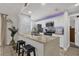 Stylish kitchen island with granite countertop, bar stools, and a textured backsplash for a modern touch at 5575 Garden Grove Cir, Winter Park, FL 32792
