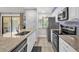 Bright kitchen featuring stainless steel appliances, granite countertops, and a window with natural light at 5575 Garden Grove Cir, Winter Park, FL 32792