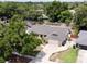 Aerial view of a house with a long driveway, fenced yard, mature trees and a two car garage in a quiet neighborhood at 5724 Pitch Pine Dr, Orlando, FL 32819