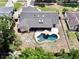 Aerial view of house featuring a kidney shaped in-ground pool, screened porch and fenced yard in a neighborhood at 5724 Pitch Pine Dr, Orlando, FL 32819