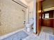 Tiled bathroom with walk-in shower, toilet, and adjacent door to another bathroom area, offering classic design at 5724 Pitch Pine Dr, Orlando, FL 32819