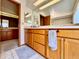 Bathroom features vanity with wood cabinets, ample counter space, and adjacent door to another bathroom, convenient layout at 5724 Pitch Pine Dr, Orlando, FL 32819