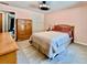 Charming bedroom with a light pink walls, wood furniture, and soft carpeting at 5724 Pitch Pine Dr, Orlando, FL 32819
