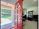 Front door opens to a bright room with an office space, featuring a desk, keyboard, and music equipment at 5724 Pitch Pine Dr, Orlando, FL 32819