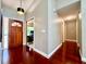 Inviting entryway featuring a wood door, cherry floors, and modern lighting at 5724 Pitch Pine Dr, Orlando, FL 32819