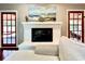 Cozy fireplace featuring a white brick surround, mantle, and decorative accents at 5724 Pitch Pine Dr, Orlando, FL 32819