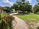 A beautifully landscaped front yard with mature trees and a charming walkway welcomes you to this inviting home at 5724 Pitch Pine Dr, Orlando, FL 32819