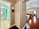 Hallway leading to an updated bathroom with a shower, toilet, and vanity, and opens up to a living area at 5724 Pitch Pine Dr, Orlando, FL 32819